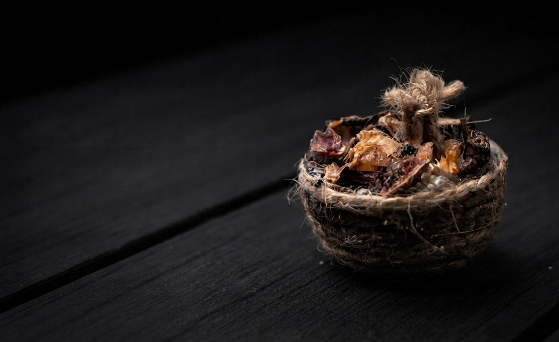 Always Fyr natural wood-and-wax fire starter with jute wick on a dark charcoal background